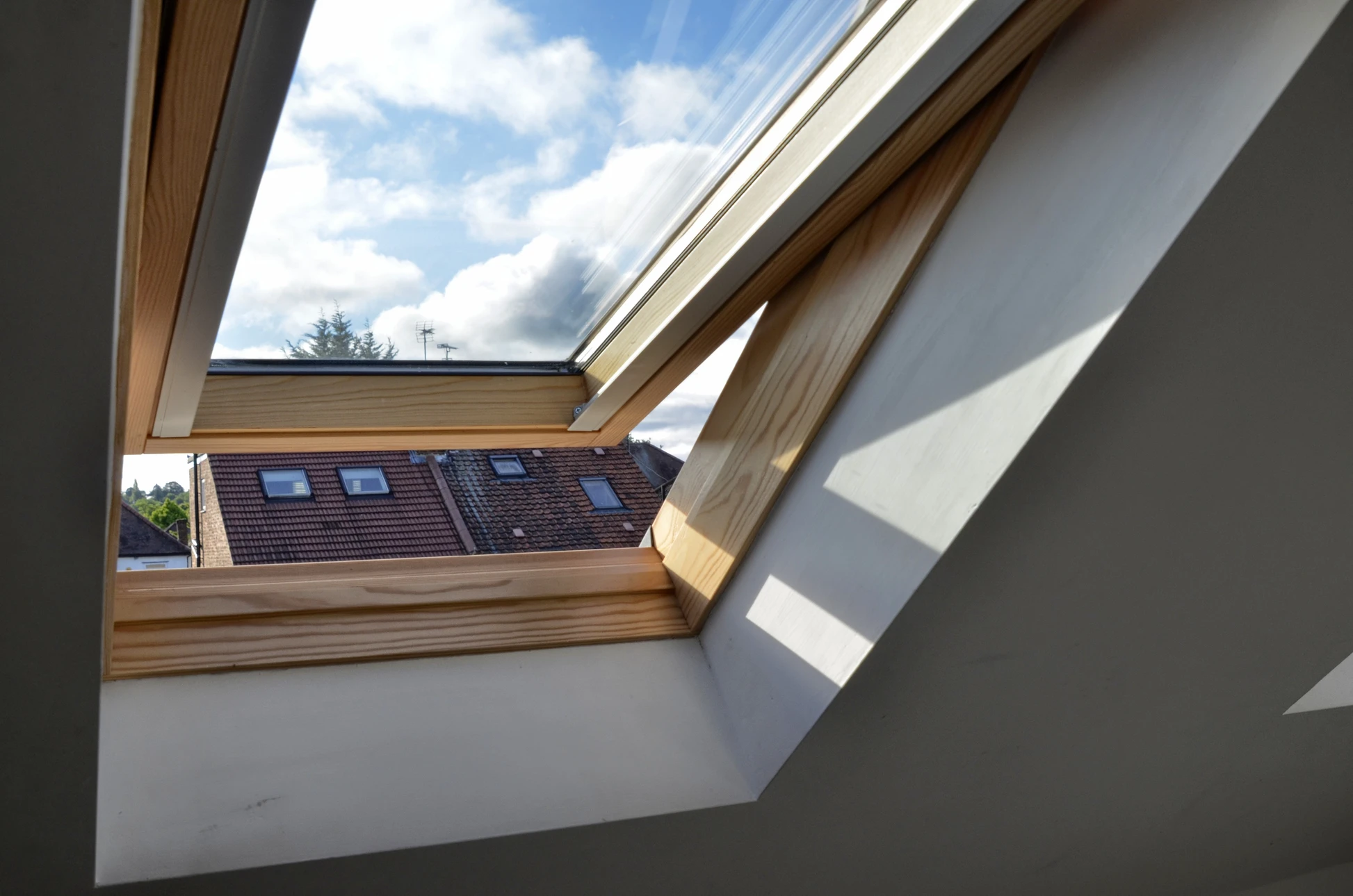 Chantier de toiture extérieur avec ouvriers installant une fenêtre de toit